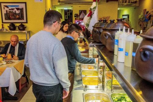 a group of people standing at a buffet line at HOTEL ALONSO DE ERCILLA in Concepción