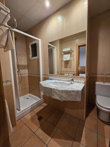 a bathroom with a sink and a toilet at Rambla Alicante Contactless in Alicante
