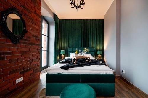 a bedroom with a brick wall and a large bed at Restored Factory Residence - 55m2, Top Location - by Rentujemy in Łódź