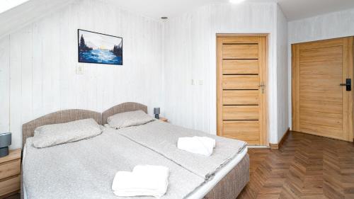 a bedroom with a large bed with two white pillows at Eleven in Karpacz