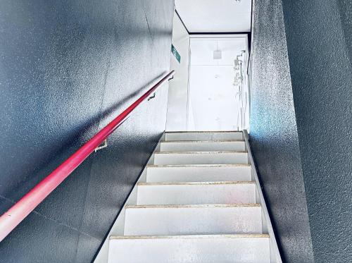 a stairway leading up to a door in a building at GR HONKAWA - Global Resort Hotel in Hiroshima