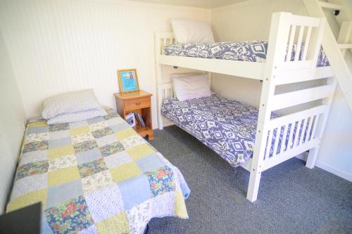 a bedroom with a bed and a bunk bed at Genas's Sierra Inn & Restaurant in Dunlap