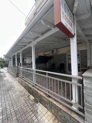 a building with a sign on the side of it at Hotel Orion Apartment in Katerini