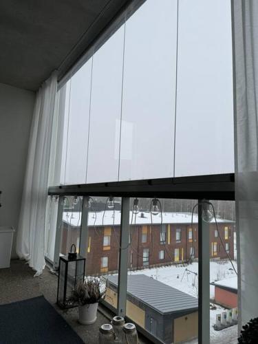 a large window with a view of a building at Modern apartment in great location in Vantaa