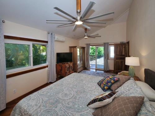 a bedroom with a bed and a ceiling fan at Blue Orchid in Jobs Bight