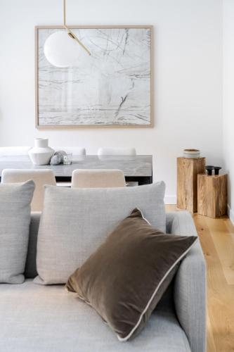 a living room with a gray couch with a painting on the wall at Luxury Central Mayfair Townhouse with AC 3BR 3BA in London