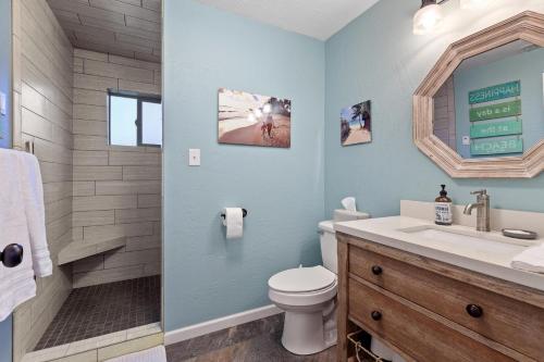 a bathroom with a toilet and a sink and a shower at West Fairway in Coeur d'Alene