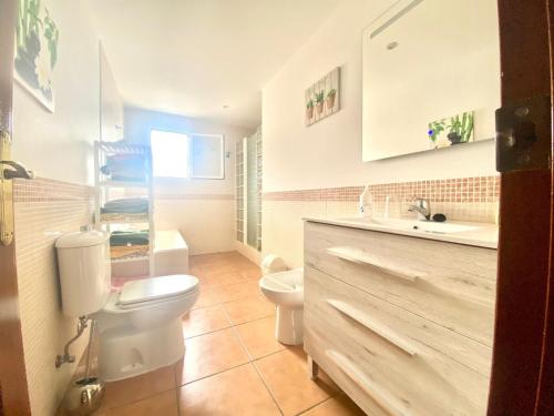łazienka z białą toaletą i umywalką w obiekcie Casa Cony w mieście Tarifa