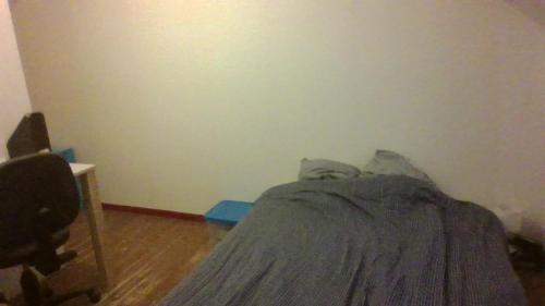 ein kleines Schlafzimmer mit einem Bett und einem Schreibtisch in der Unterkunft Chambre dans maison in Betton