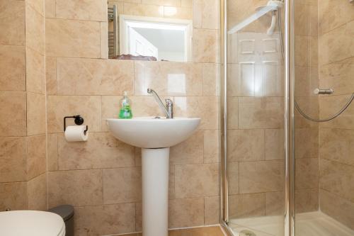 a bathroom with a sink and a shower at 33 Stanley Road in Northampton