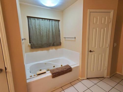 a bath tub in a bathroom with a window at Master Bed & Bath Just For You in Bentonville