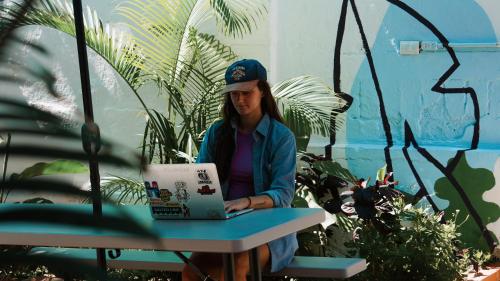 a woman sitting at a table with a laptop at El Sofá Caracas in Caracas