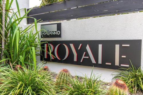 a sign on the side of a building with plants at Royale Escape in Cardiff Hall