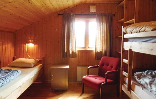 a bedroom with a bed and a chair in a room at Sulseter Fjellstugu in Vinstra