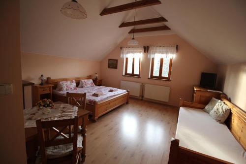 a bedroom with a bed and a table and chairs at Penzion Na Statku in Starý Vestec