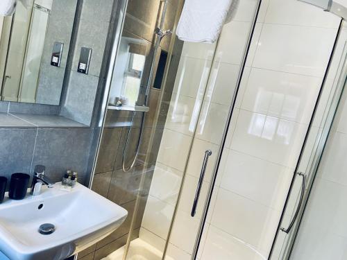 a bathroom with a sink and a shower at The Diamond Inn in Ponteland