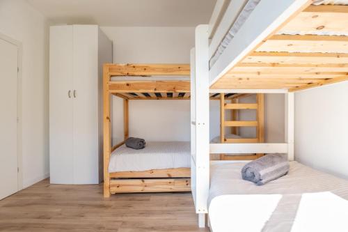 a bedroom with two bunk beds and a ladder at Roof Top 3 Floors in Netanya