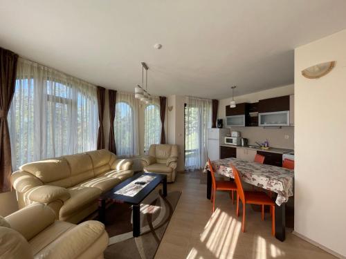 a living room with a couch and a table at Cassiopea Villas in Pamporovo