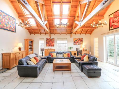 a large living room with couches and a table at The Lodge in Grantham