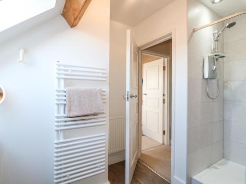 a bathroom with a walk in shower and a toilet at The Lodge in Grantham