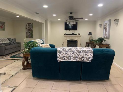 a living room with a blue couch and a fireplace at Entire Apartment Suite family singles Couples Nurses dinners business meetings in Lithonia
