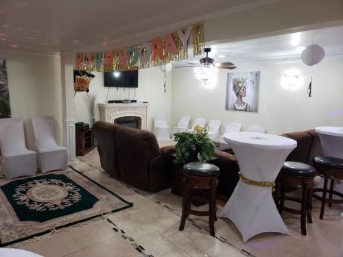 a living room with a couch and a table and chairs at Entire Apartment Suite family singles Couples Nurses dinners business meetings in Lithonia