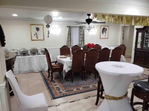 a dining room with a white table and chairs at Entire Apartment Suite family singles Couples Nurses dinners business meetings in Lithonia