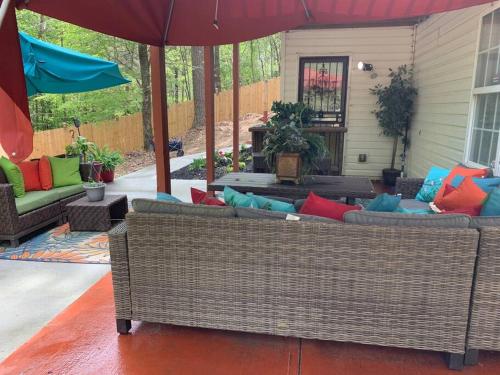 a patio with two couches and an umbrella at Entire Apartment Suite family singles Couples Nurses dinners business meetings in Lithonia