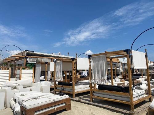 a group of beds sitting on a patio at Apartmani Vesna Paralia in Paralia Katerinis