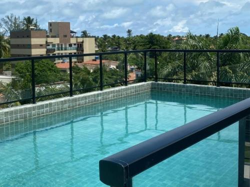 a swimming pool on top of a building at Flat 402 Centro Porto Galinhas in Porto De Galinhas