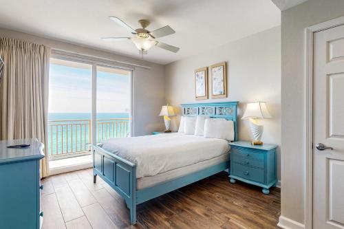 a bedroom with a bed with a view of the ocean at Splash Resort 907W in Panama City Beach