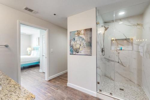 a bathroom with a walk in shower next to a bedroom at Splash Resort 907W in Panama City Beach