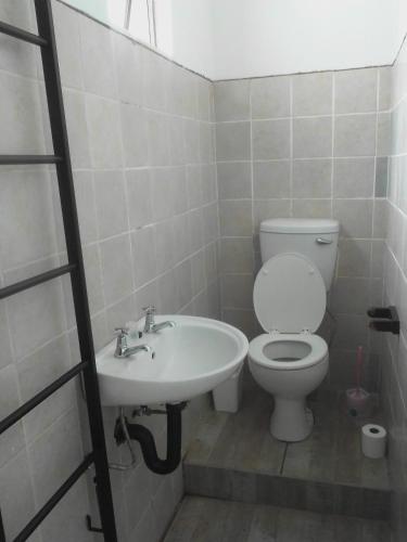 a bathroom with a toilet and a sink at Studio house in Durban