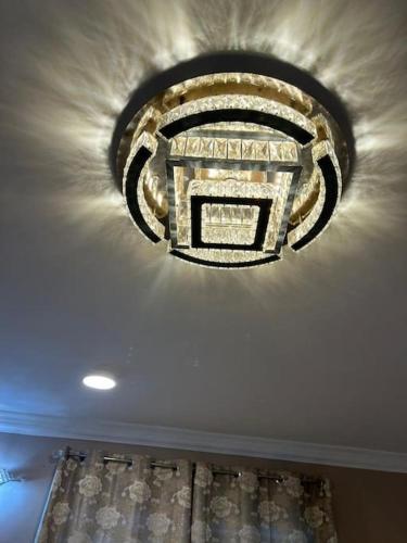 a chandelier hanging from a ceiling in a room at Cozy home in East Legon Hills in Accra