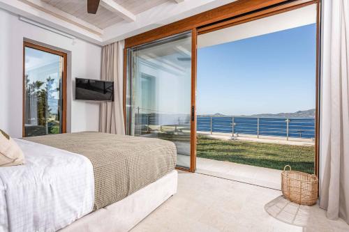 a bedroom with a bed and a view of the ocean at Alba Thesan in Marathias