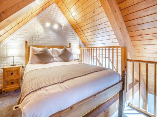 a bedroom with a large bed in a attic at Northlands Farm Superior Chalet 2 in Chichester