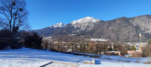 a snow covered mountain with a town in the distance at Boardinghouse in Bad Reichenhall