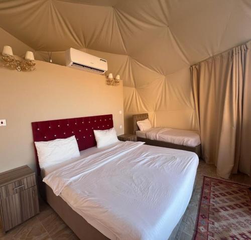 a bedroom with a bed in a tent at Scarlet Luxury Camp Wadi Rum in Wadi Rum