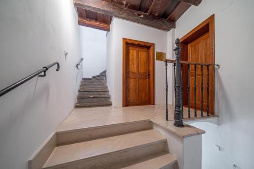 a staircase in a house with a wooden door at Central apartment in Olomouc