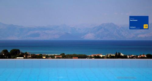a large swimming pool with a view of the mountains at Red Queen in Sfakerá
