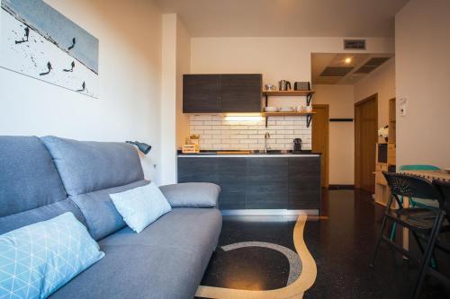 a living room with a couch and a kitchen at Apartamentos Dada in Zarautz