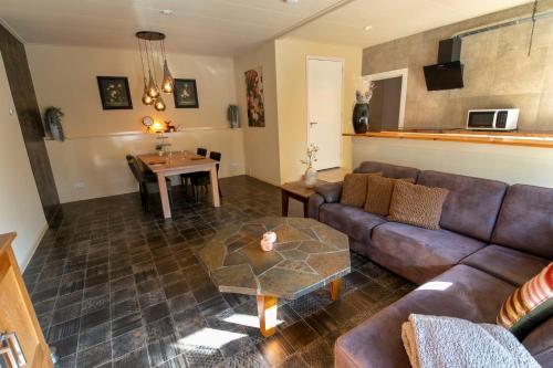 a living room with a couch and a table at Appartement Carlijn in Diever