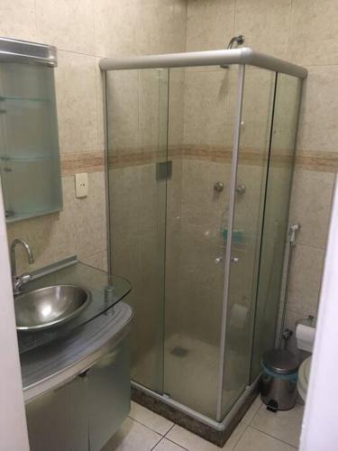 a bathroom with a glass shower and a sink at Av Atlântica - Beira Mar de Copacabana - posto4 in Rio de Janeiro