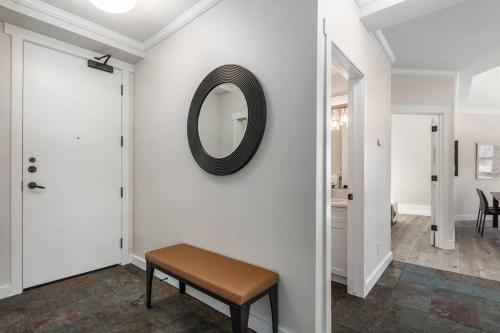 a hallway with a bench and a mirror on the wall at The Grand Escape Downtown Canmore in Canmore