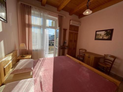 a bedroom with a large bed with a large window at Appartment centrum in Karlovy Vary