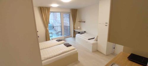 a living room with a couch and a window at Bella Apartments Brno in Brno