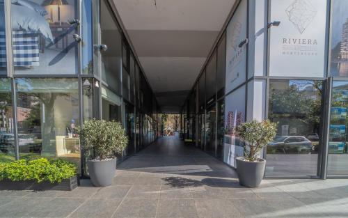 a building with potted plants in front of a street at Amare Luxury Apartments in Budva
