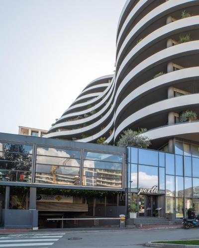 a large building with a lot of glass at Amare Luxury Apartments in Budva
