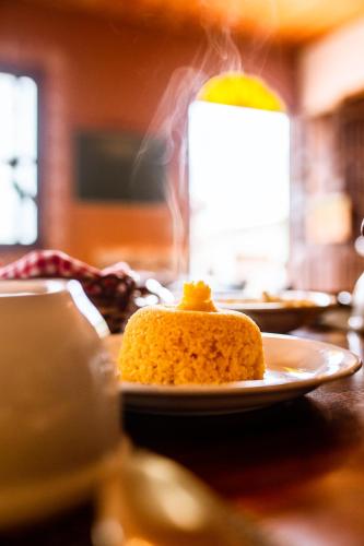 a piece of cake on a plate on a table at Pousada Tatu Feliz in Vale do Capao