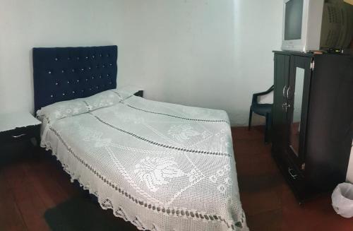a bedroom with a bed and a tv on a dresser at Hostal Perla Del Norte in Murillo